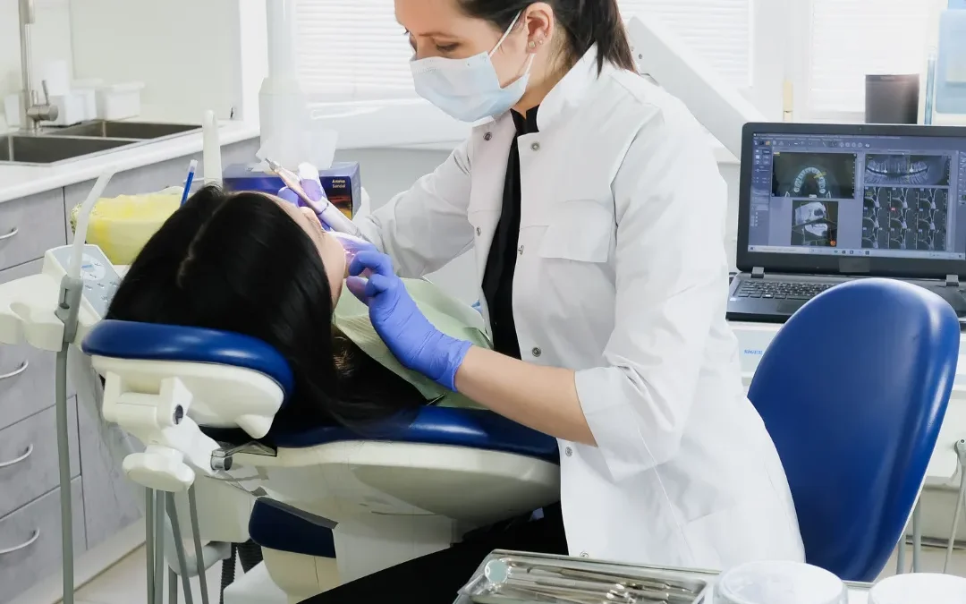 A dentist examines Patient's teeth at the clinic.